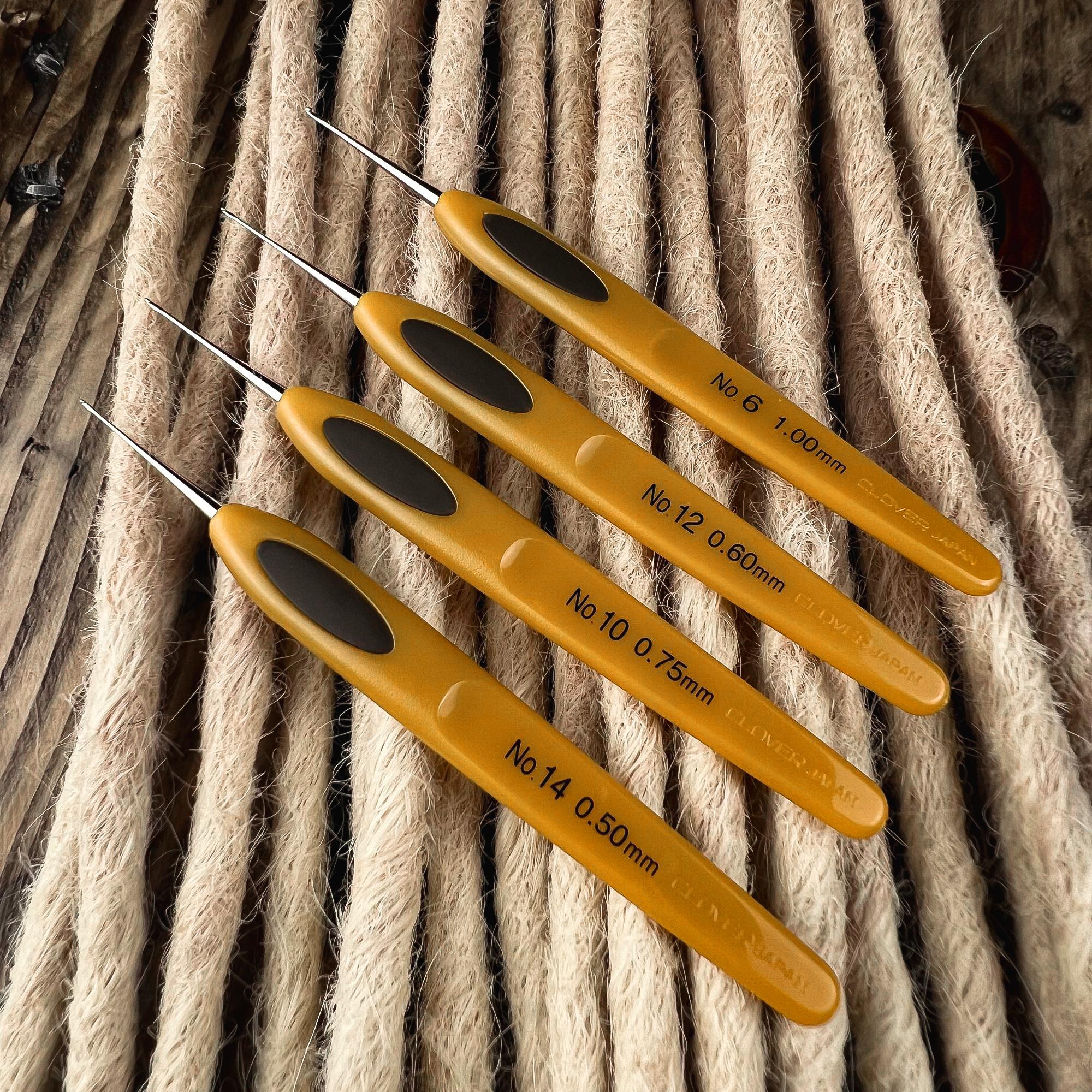Clover Micro Crochet Hooks in multiple sizes displayed on natural rope for Loc extensions and Dreadlock maintenance.