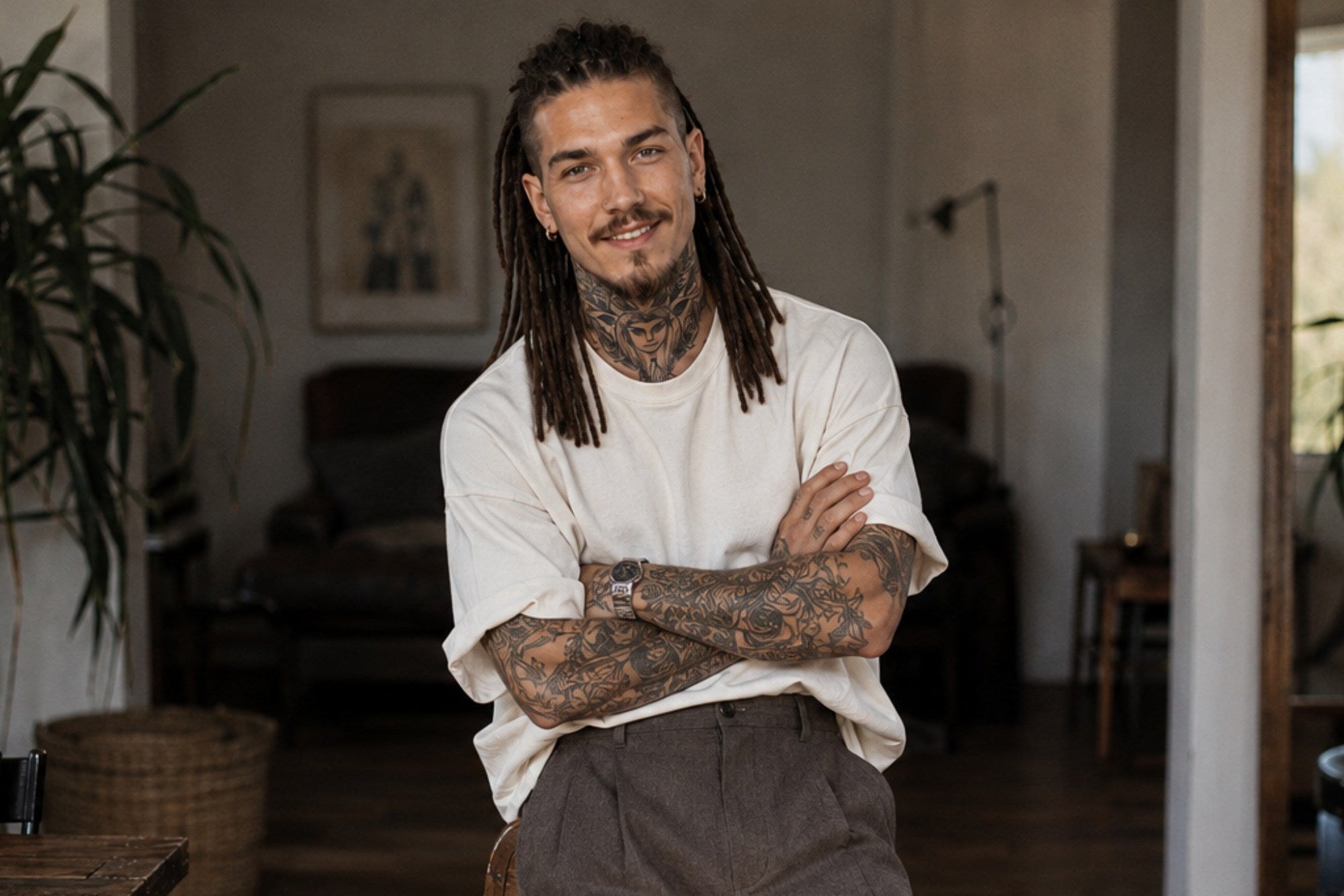 Professional loc artist wearing handcrafted loc extensions in a creative studio, representing expert craftsmanship and professional loc services.