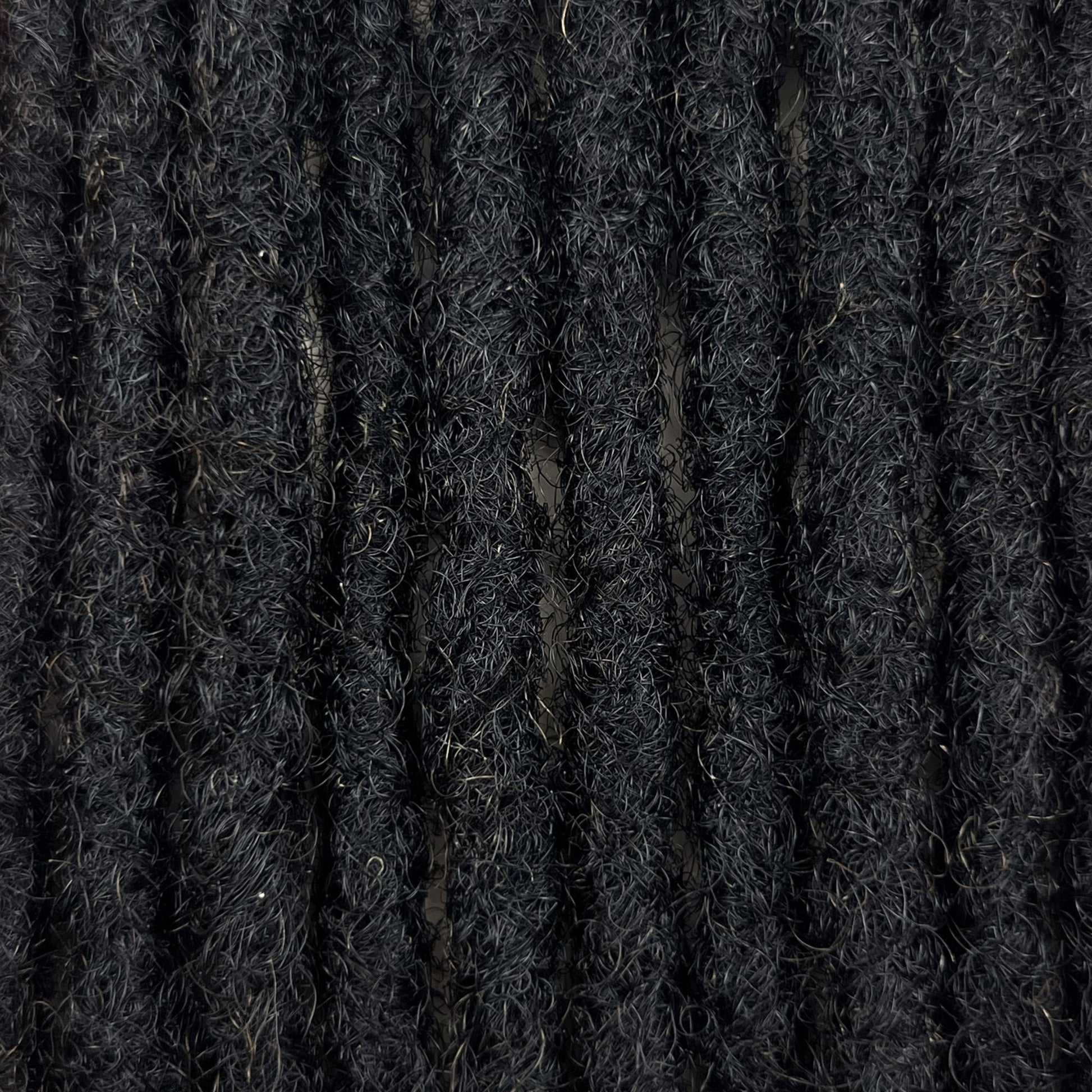 Close-up of Dark Brown kinky human hair loc extensions made using the crochet method.