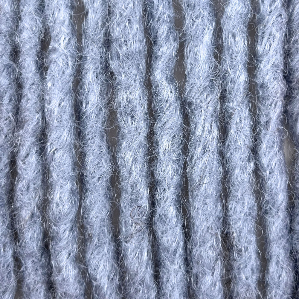 Close-up of Grey kinky human hair loc extensions made using the crochet method.