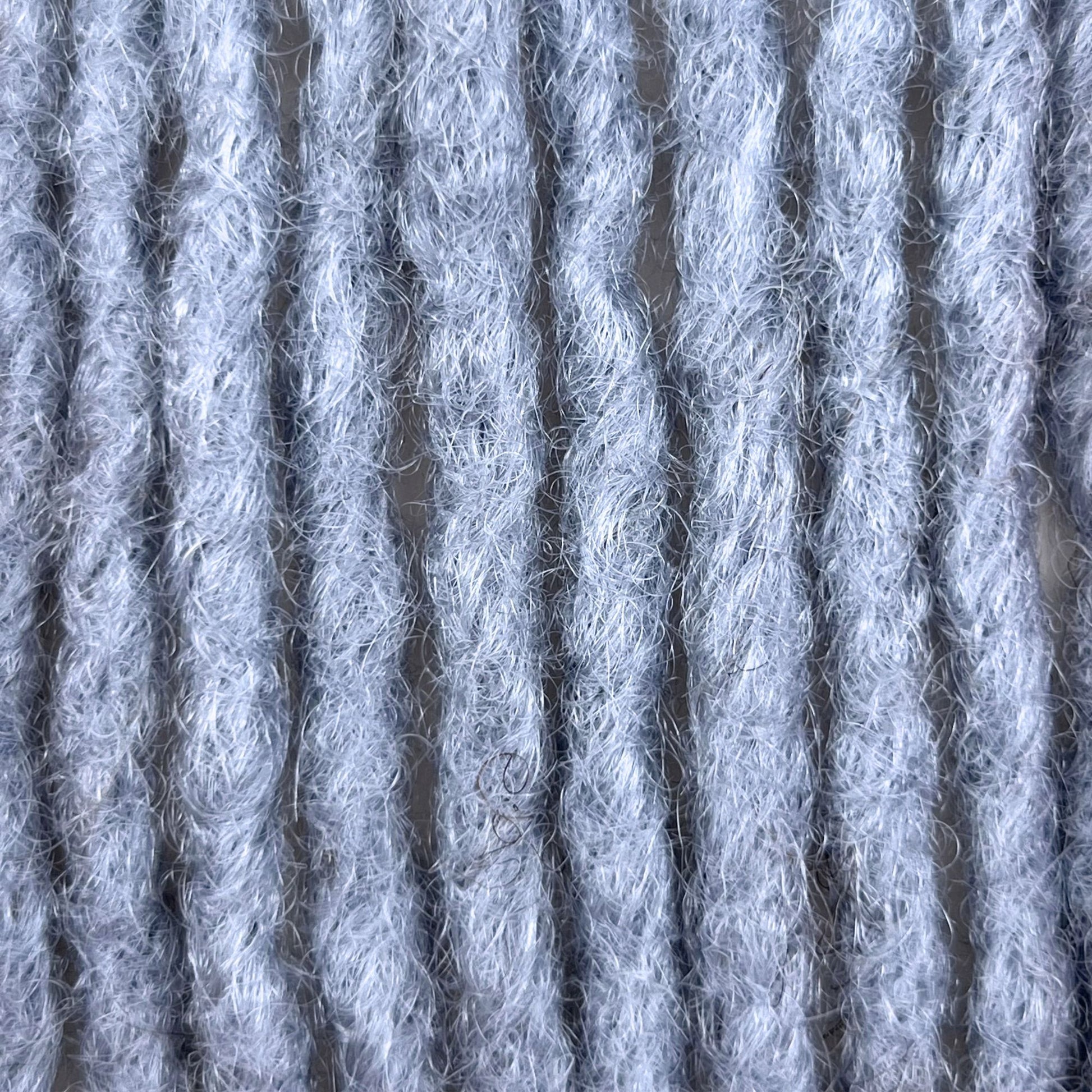 Close-up of Grey kinky human hair loc extensions made using the crochet method.
