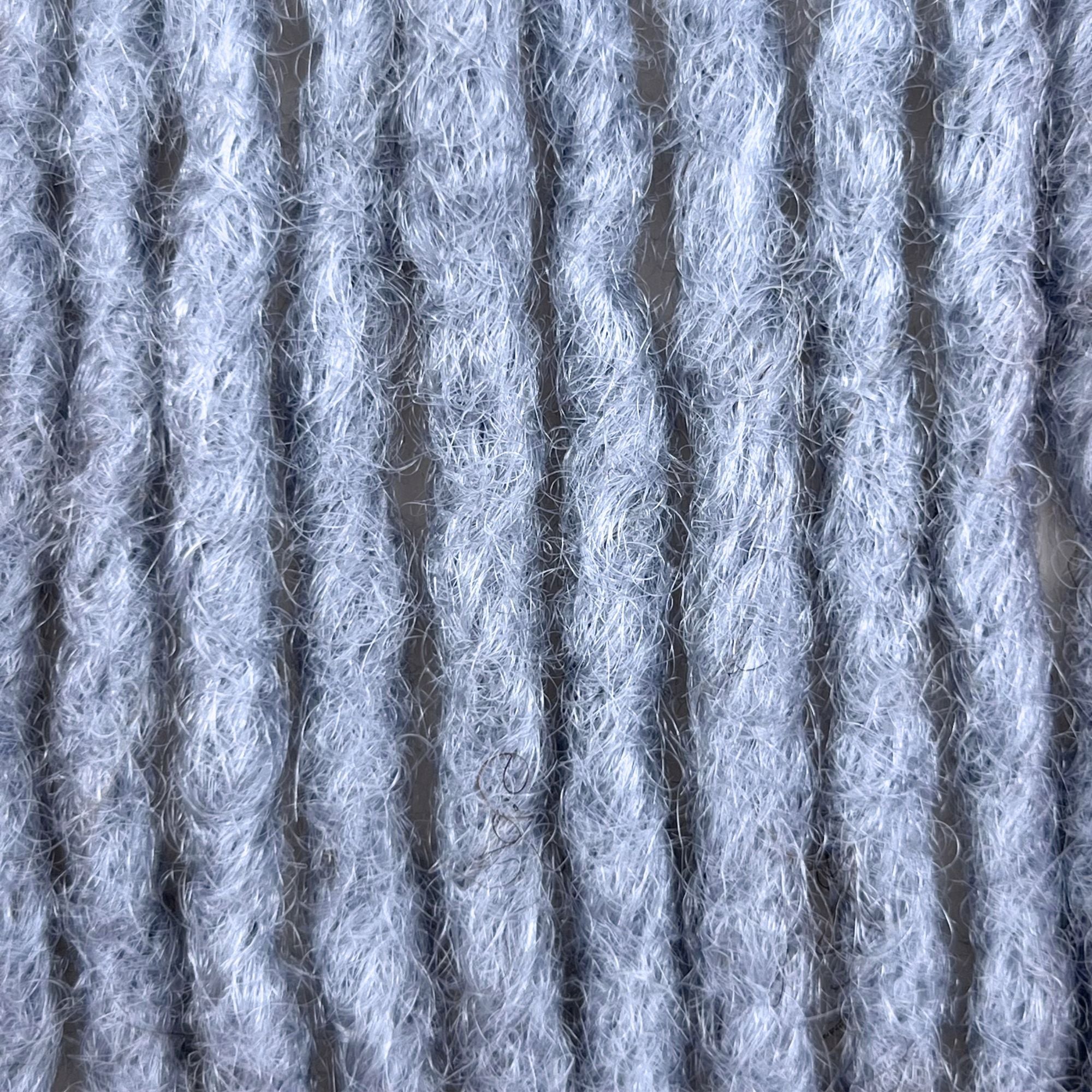 Close-up of Grey kinky human hair loc extensions made using the crochet method.