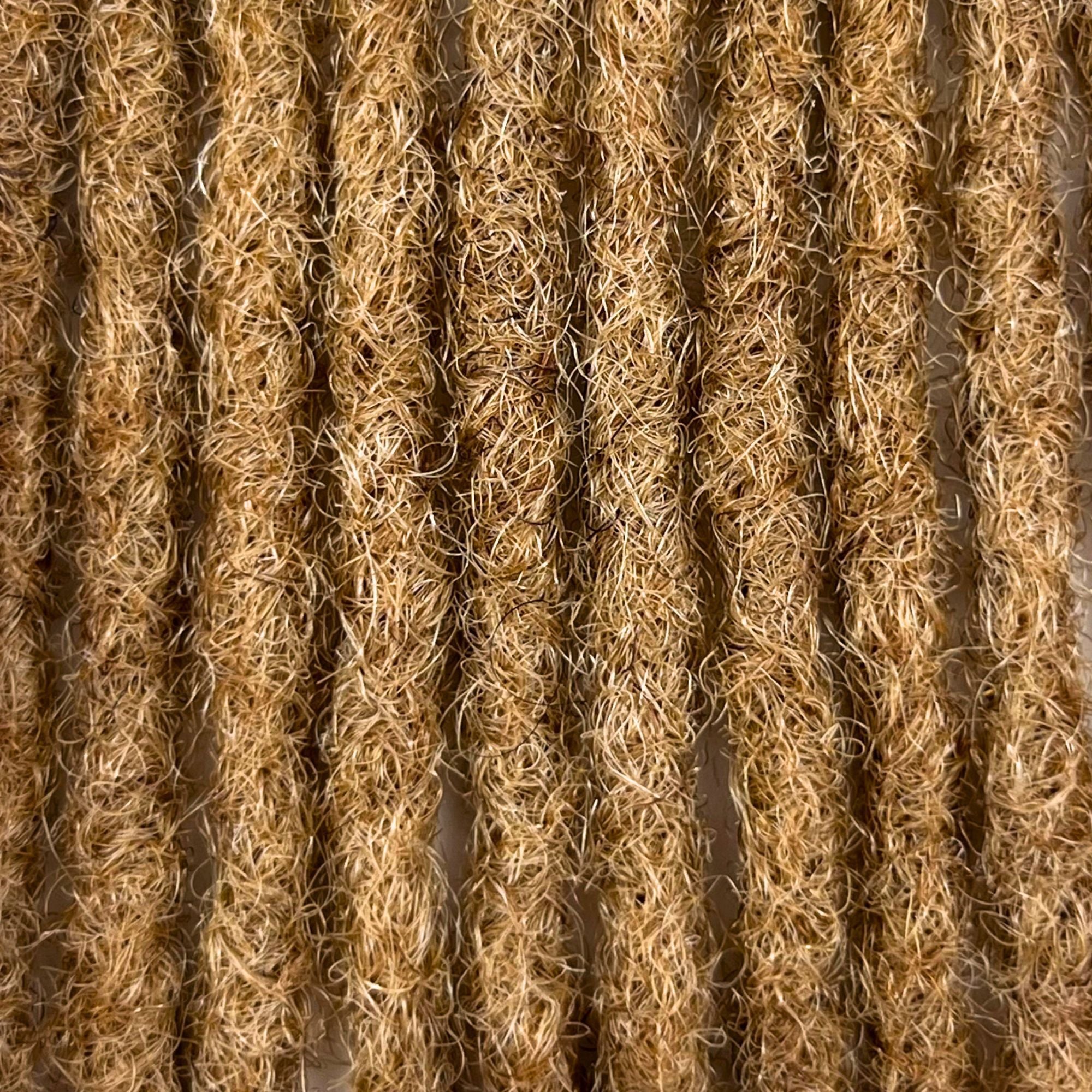 Close-up of Honey Blonde kinky human hair loc extensions made using the crochet method.