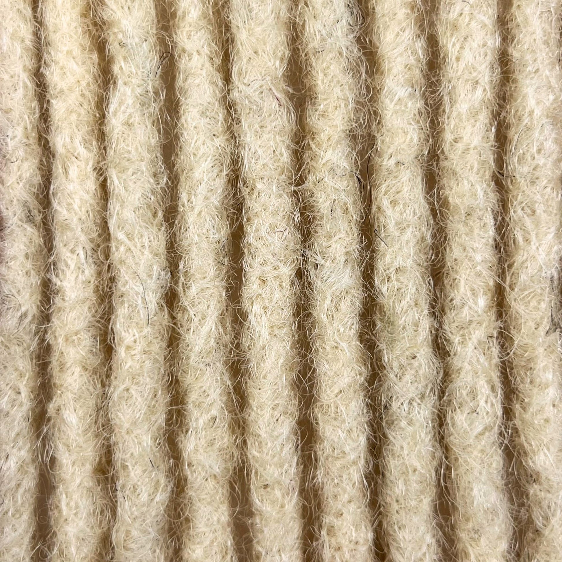 Close-up of Bleach Blonde kinky human hair loc extensions made using the crochet method.