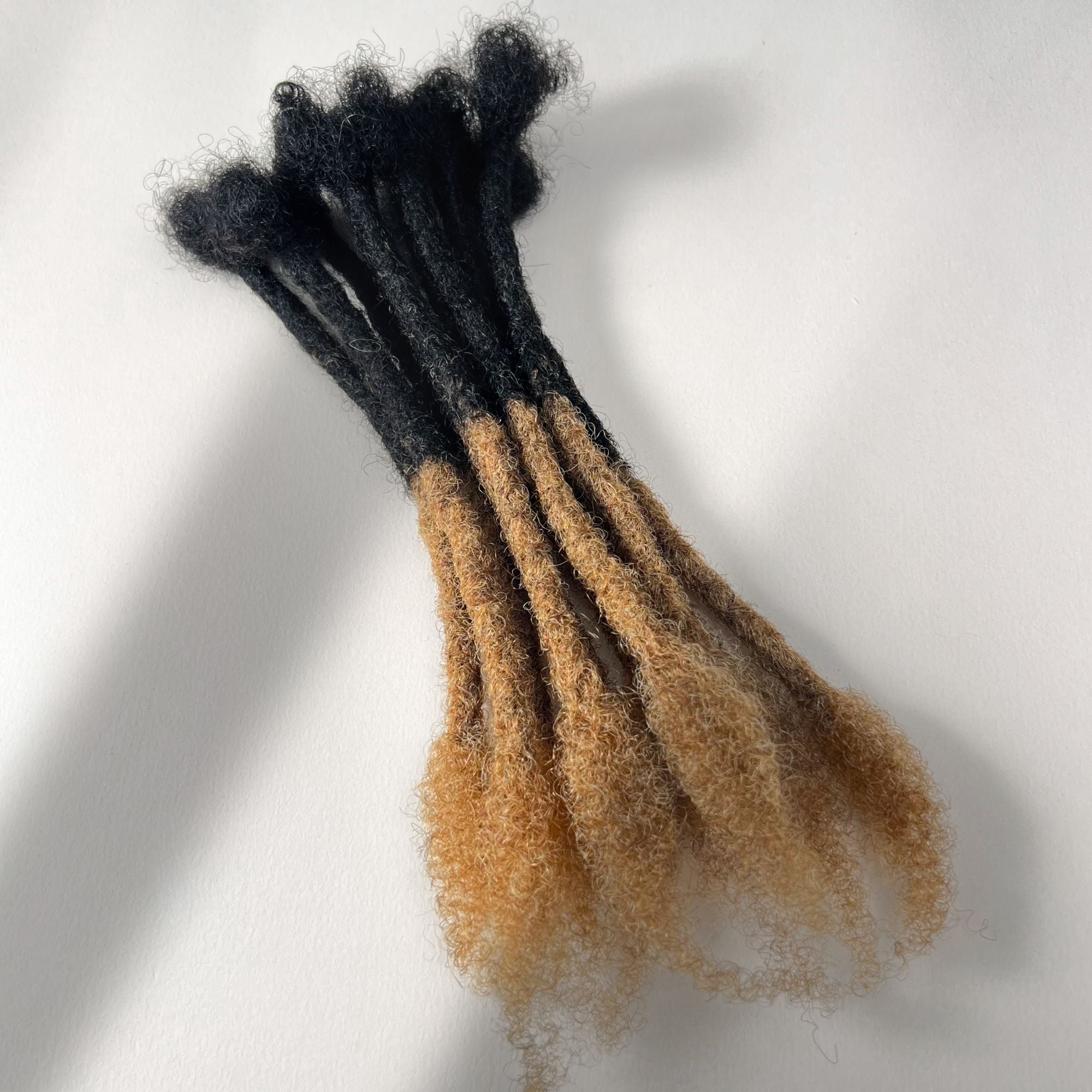 Honey Blonde Ombre kinky human hair open end loc extensions made using the crochet method.