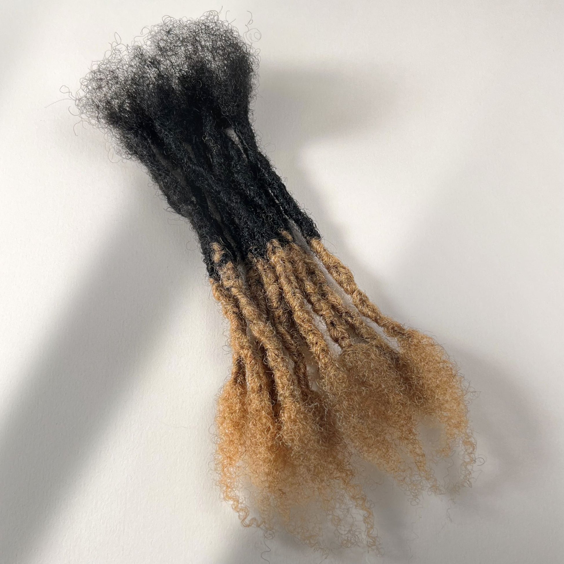 Honey Blonde Ombre kinky human hair open end loc extensions made using the interlocking method.