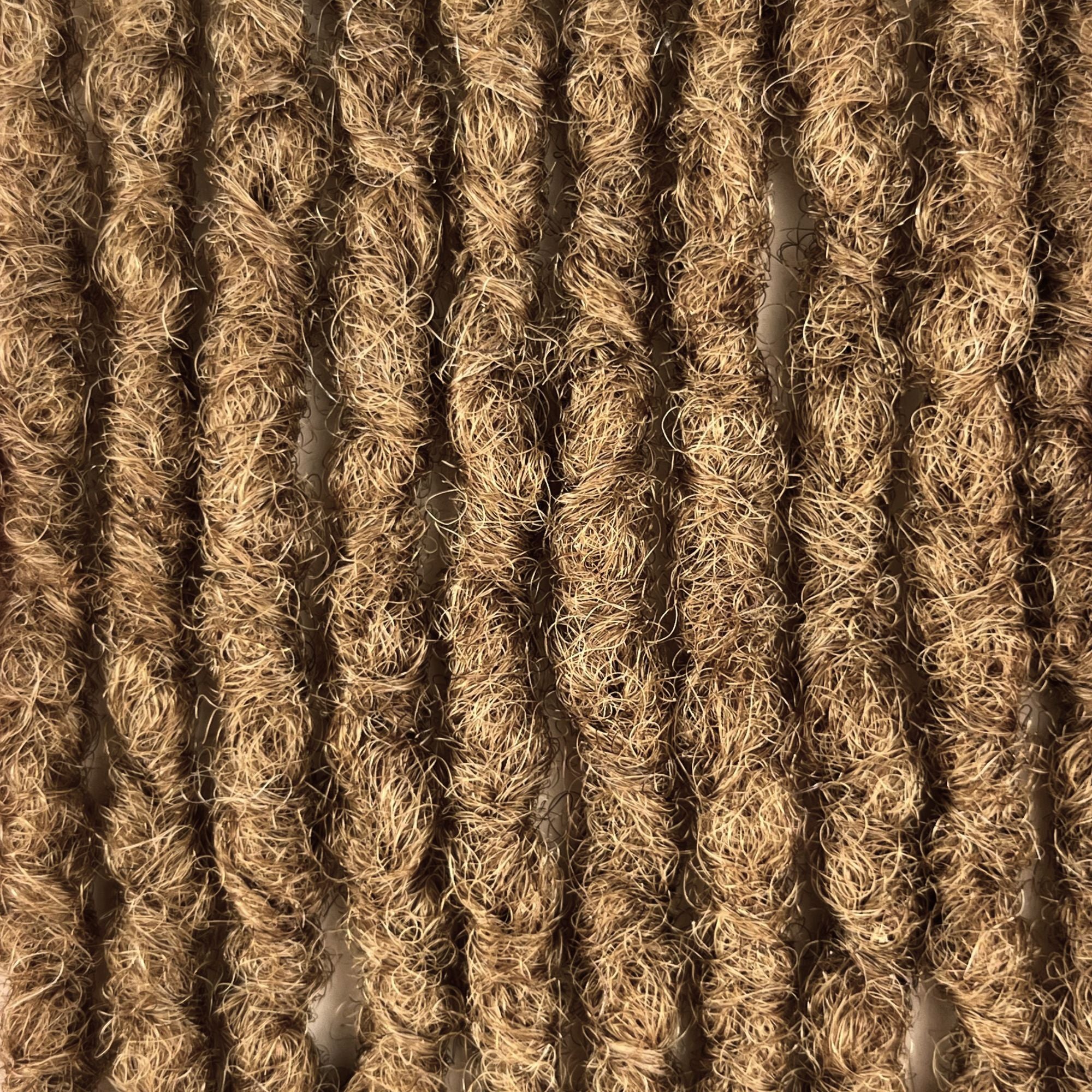 Close-up of kinky loc extensions in Honey Blonde, showing the texture and color.