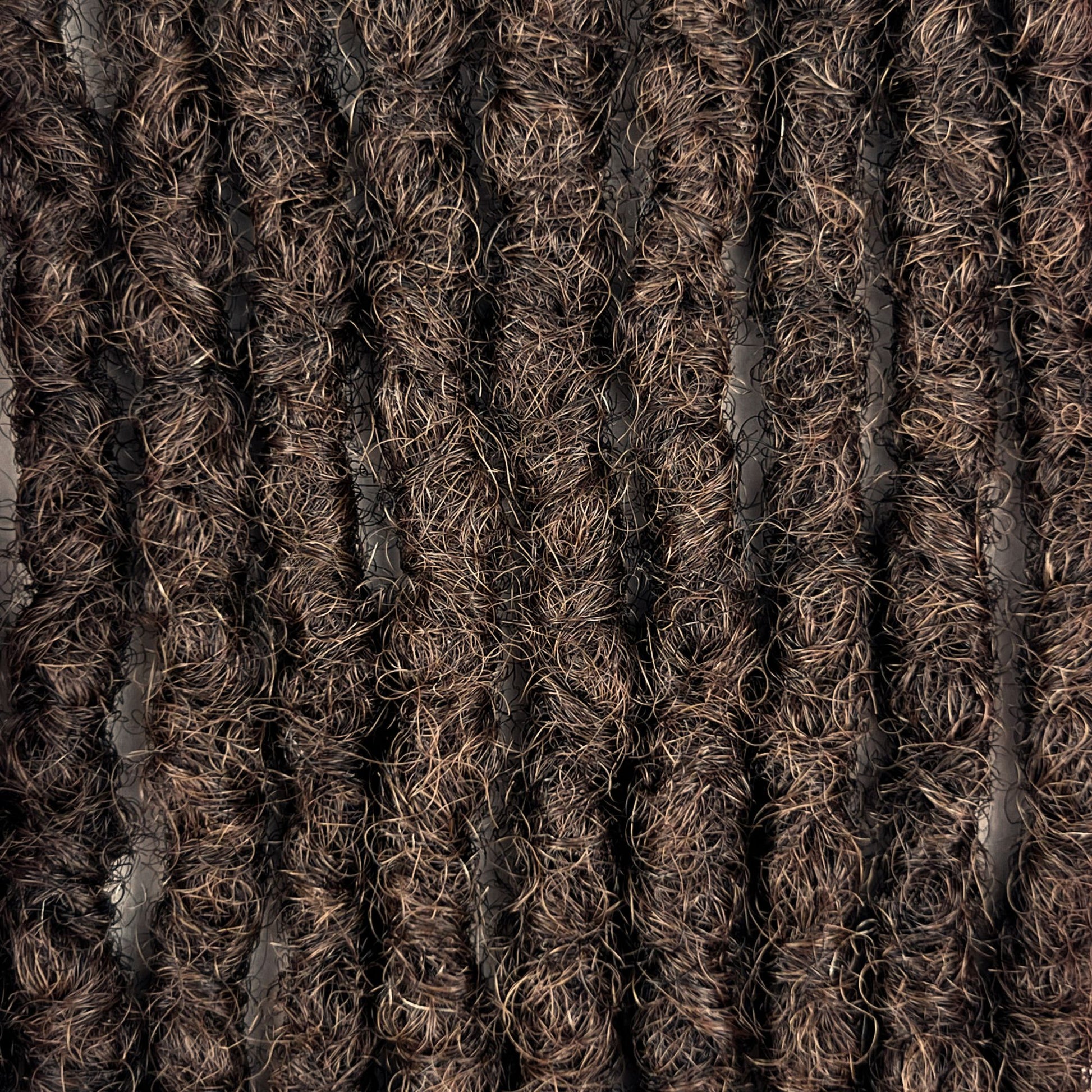Close-up of kinky loc extensions in Medium Brown, showing the texture and color.
