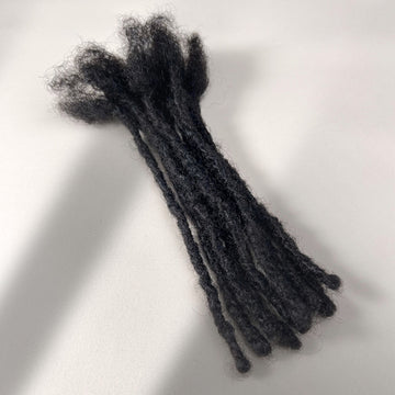 Full view of kinky loc extensions with blunt ends in Natural Black, made using the interlocking method.