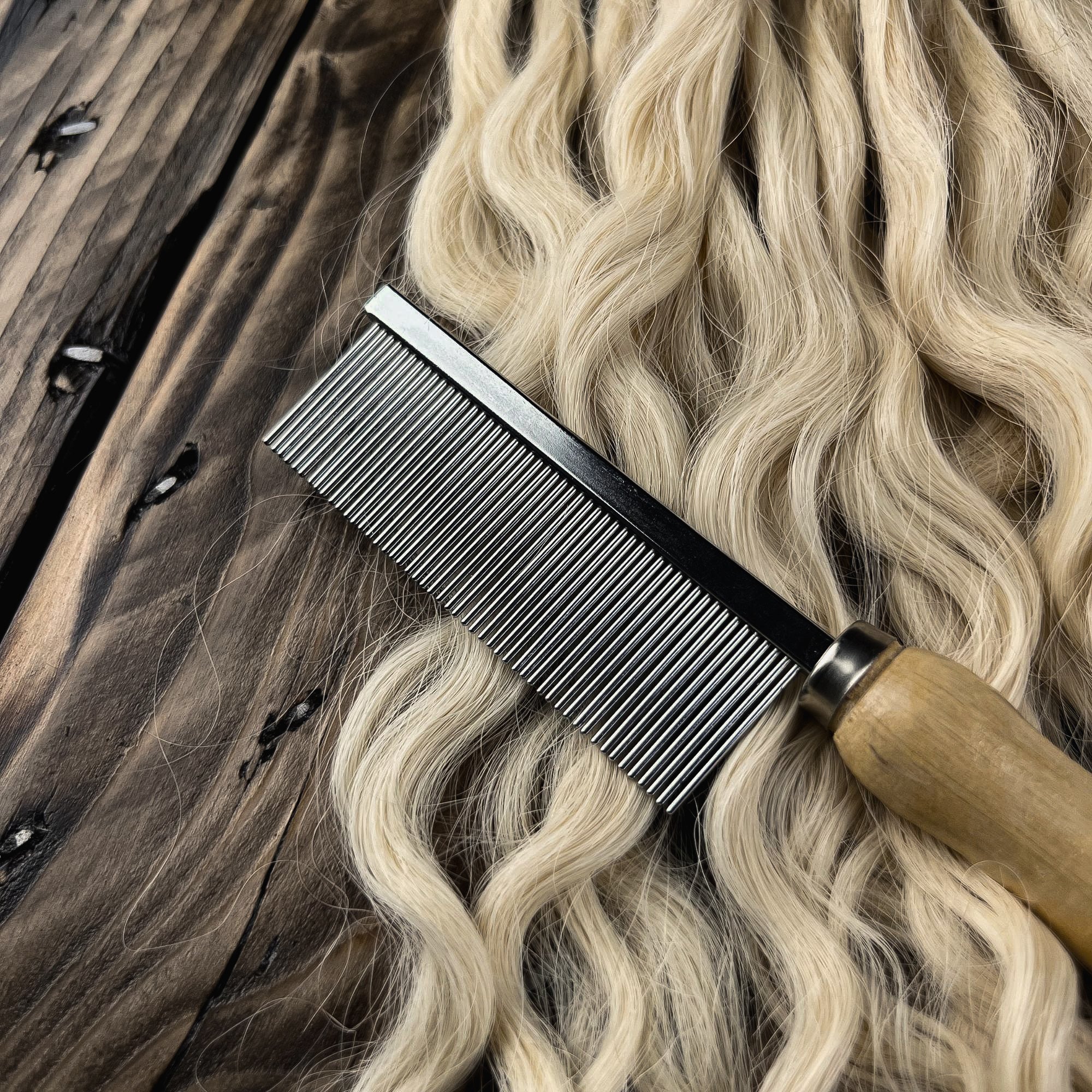 Close-up of the Loc Comb on wavy human hair for detangling, sectioning, and preparing hair for handcrafted Loc creation.