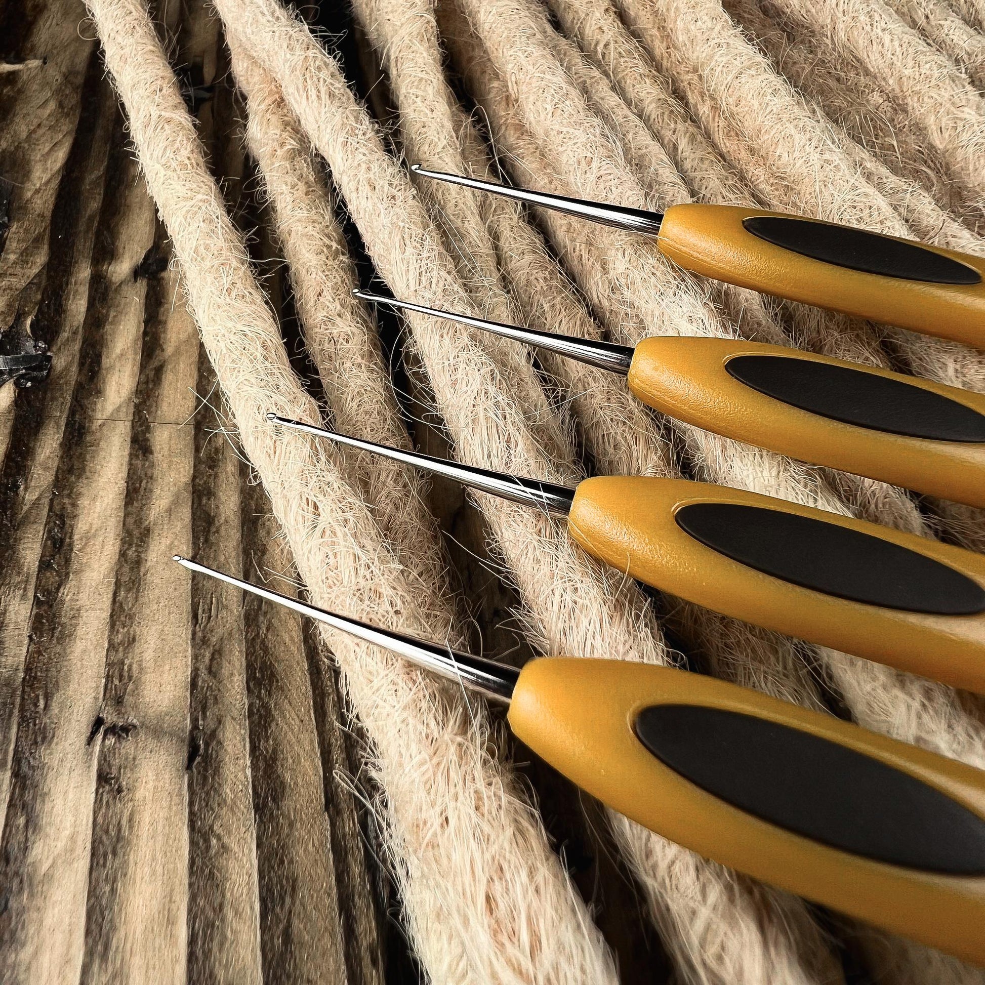 Close-up of the fine hook tips of Clover Micro Crochet Hooks for precise Loc and Dreadlock maintenance.