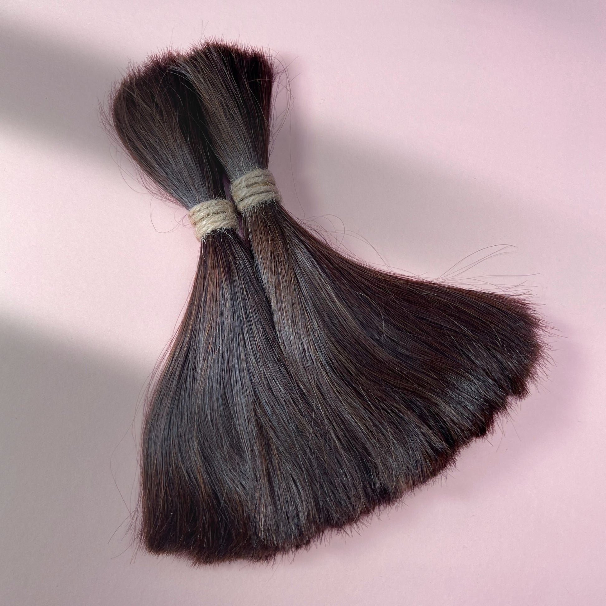 Full view of straight human hair in Warm Caramel Brown.