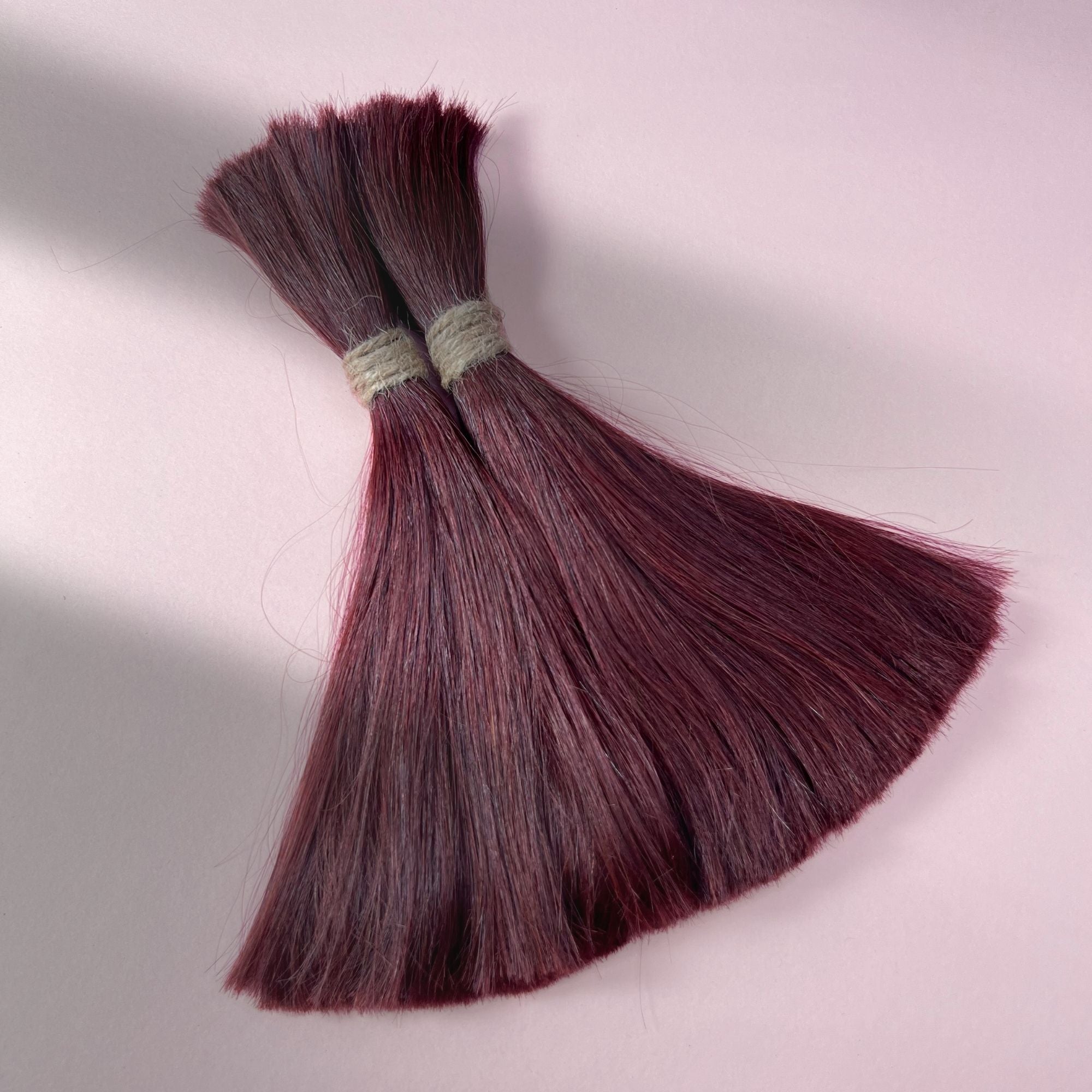 Full view of straight human hair in Deep Crimson Red.