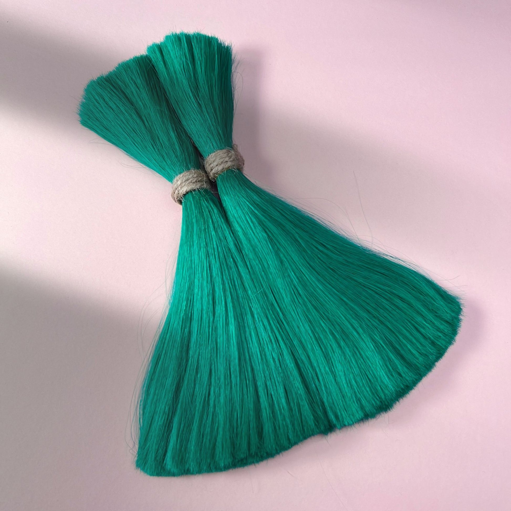 Full view of straight human hair in Emerald Green.
