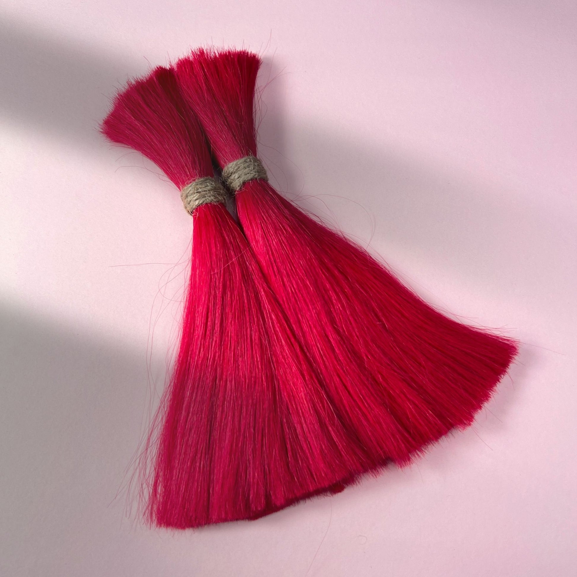 Full view of straight human hair in Indian Pink.