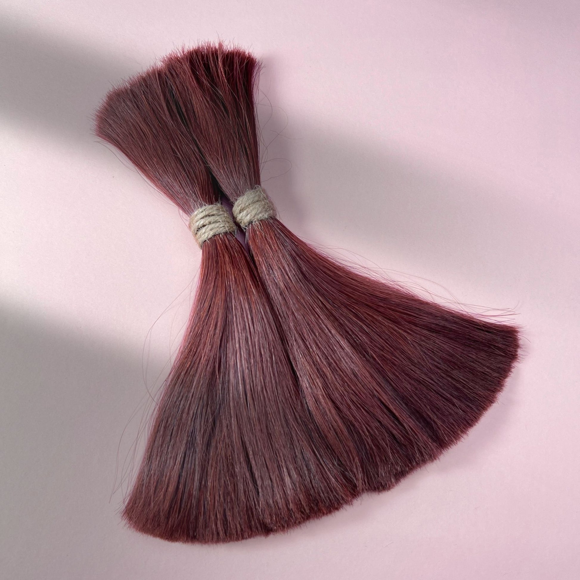 Full view of straight human hair in Warm Mahogany Red.