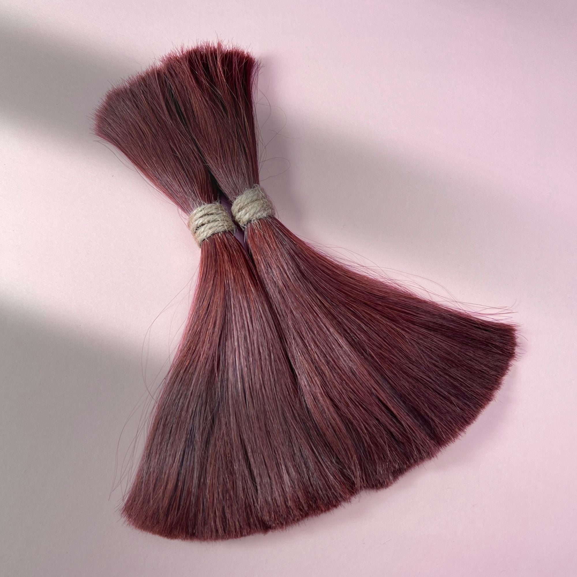 Full view of straight human hair in Warm Mahogany Red.