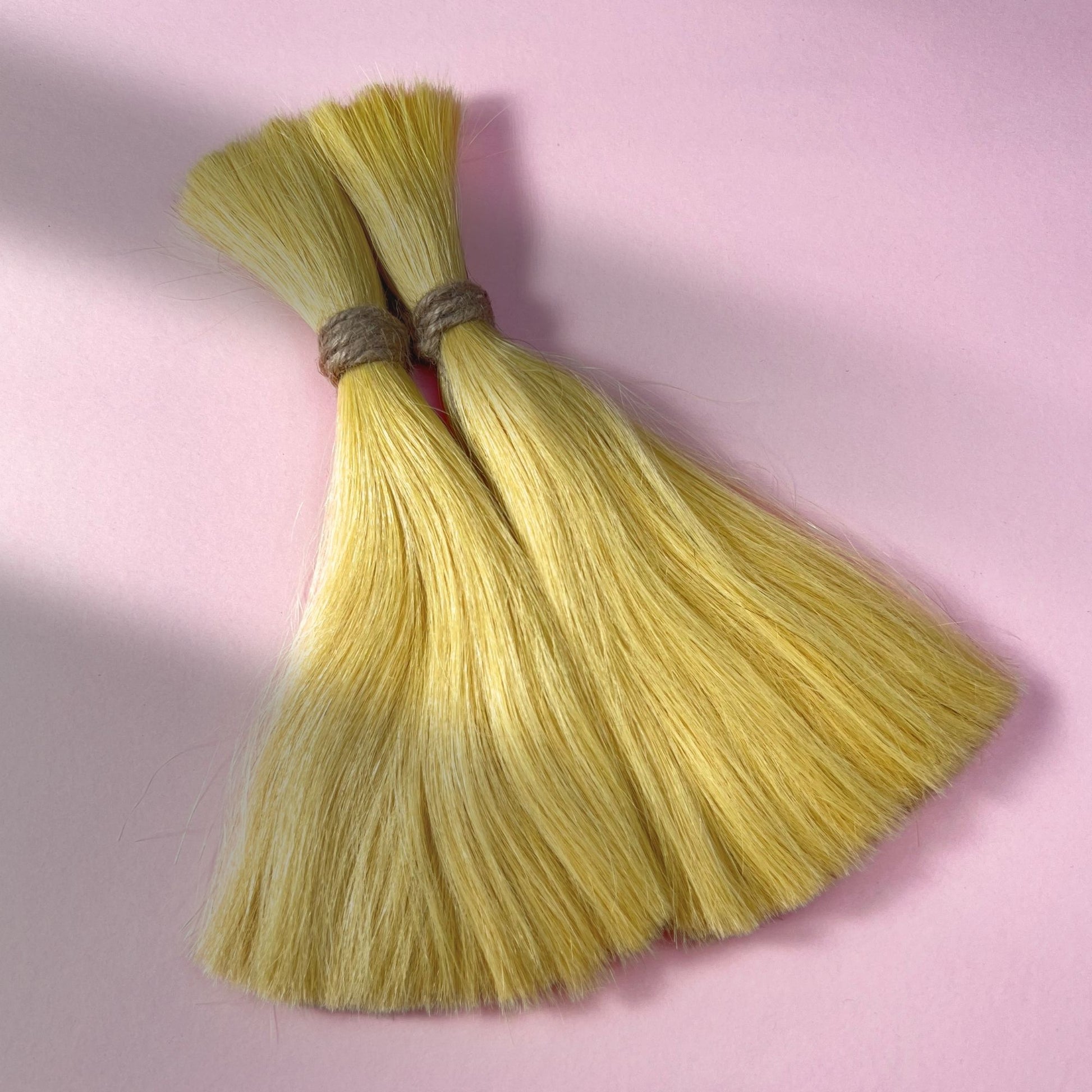 Full view of straight human hair in Soft Ochre.