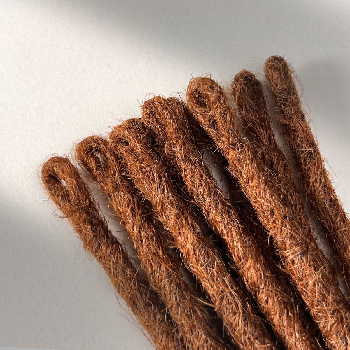 Loop detail of temporary single-ended straight loc extensions in Burnt Sienna Copper.