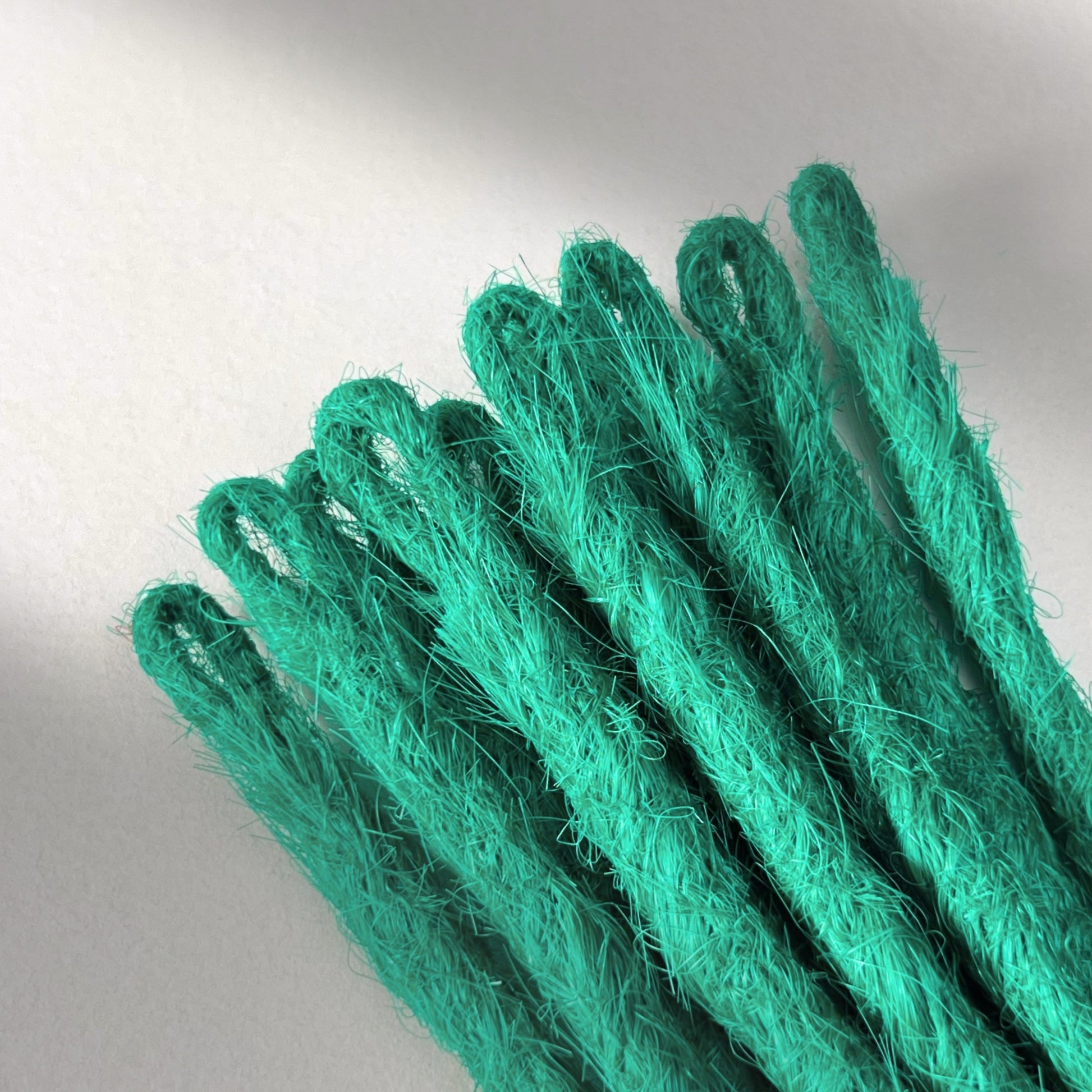 Loop detail of temporary single-ended straight loc extensions in Emerald Green.