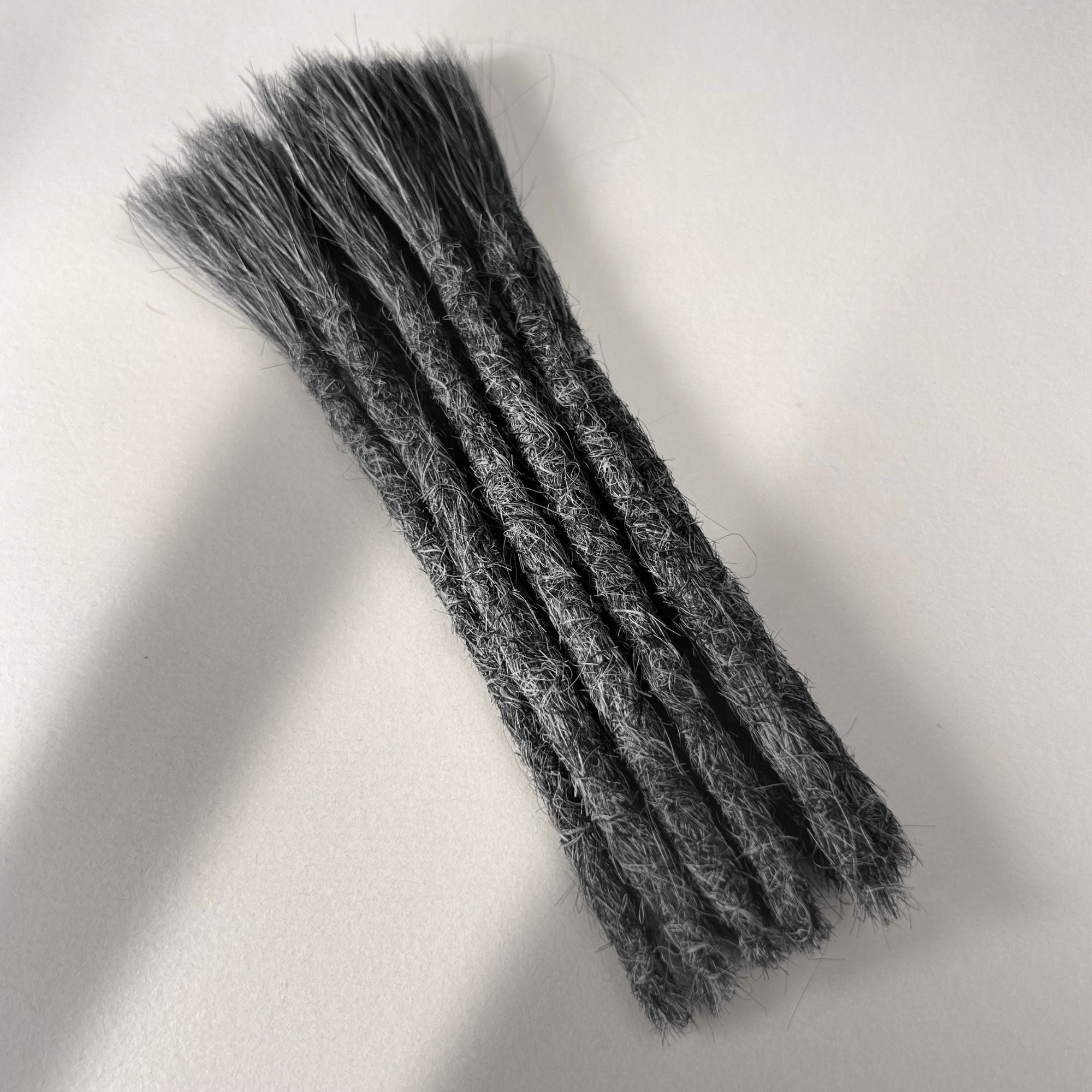 Full view of permanent straight loc extensions with blunt ends in Steel Silver.
