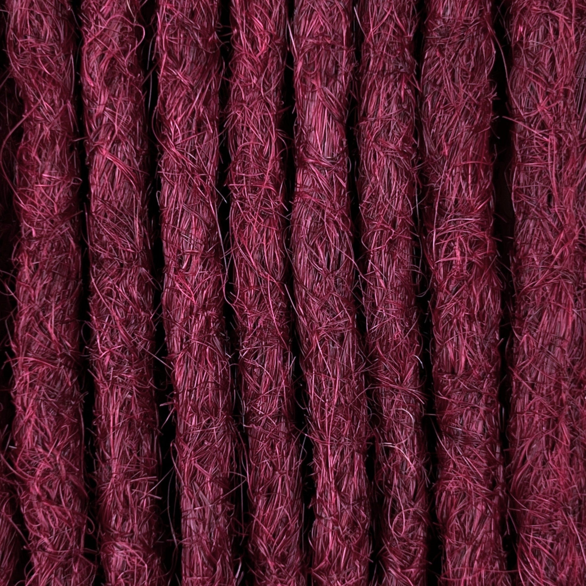 Close-up of straight loc extensions in Dark Cherry Red, showing the texture and color.