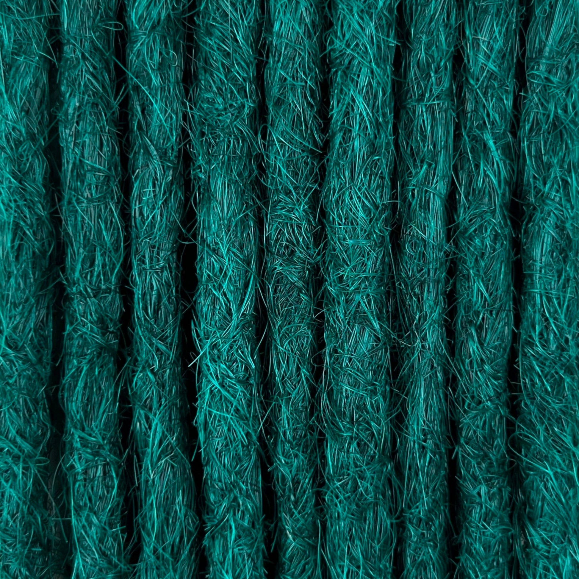 Close-up of straight loc extensions in Forest Green, showing the texture and color.