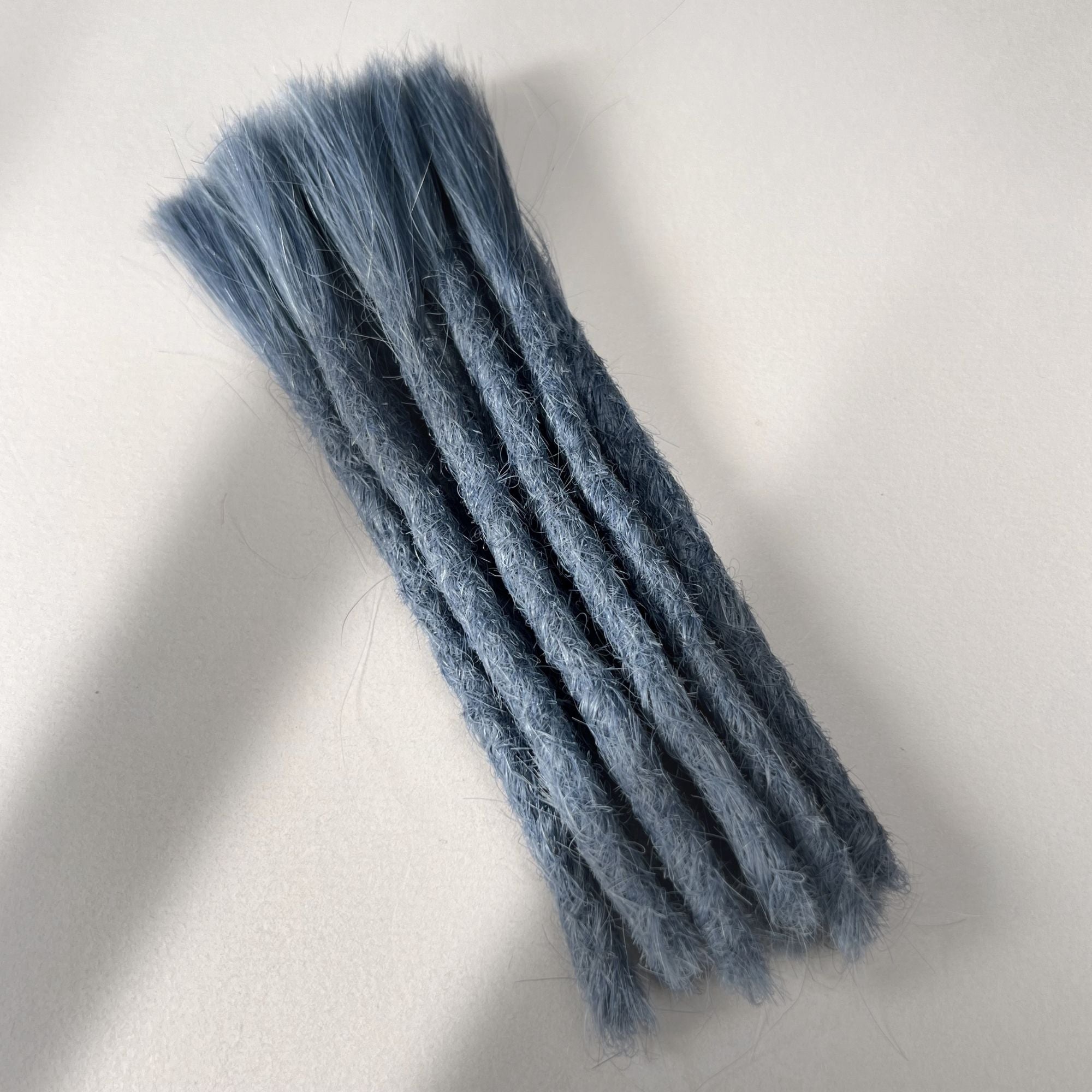 Full view of permanent straight loc extensions with blunt ends in Sky Blue.