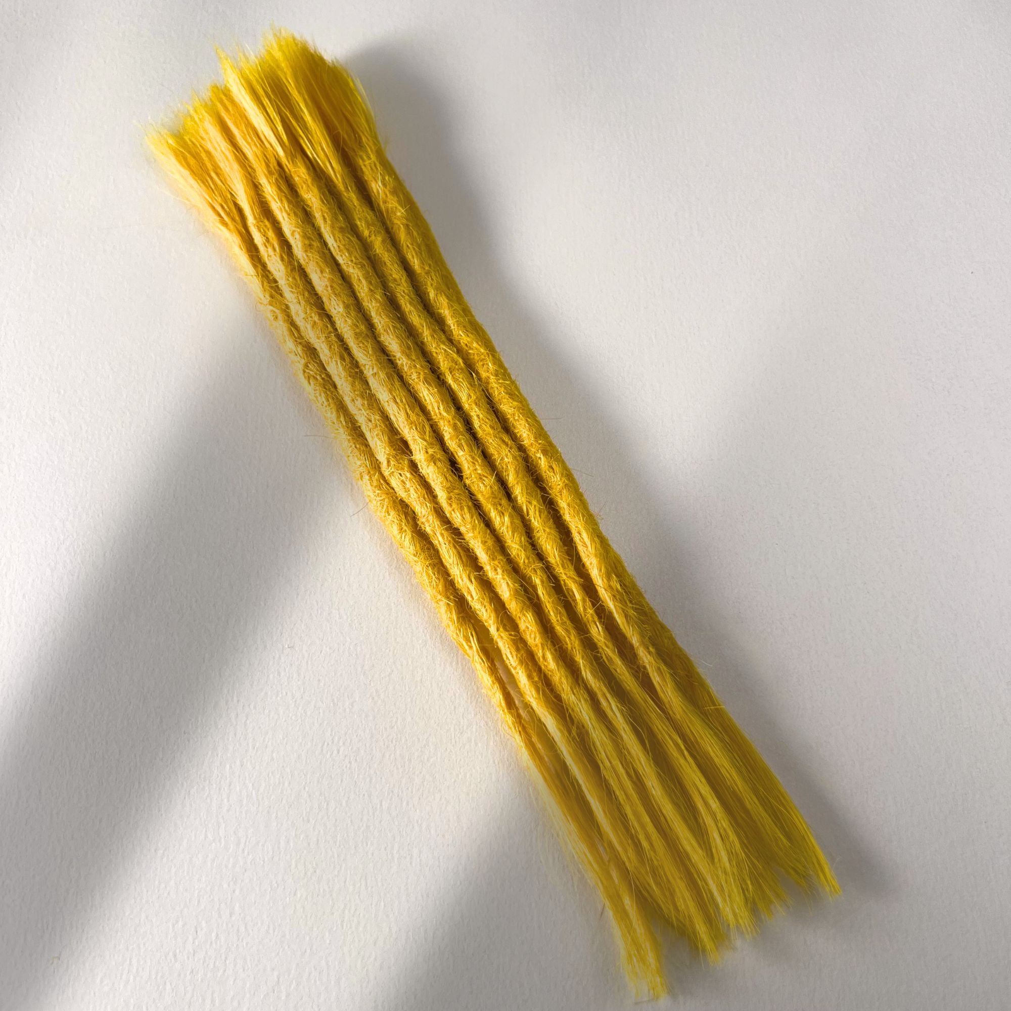 Full view of permanet straight loc extensions with open ends in Lemon Yellow.
