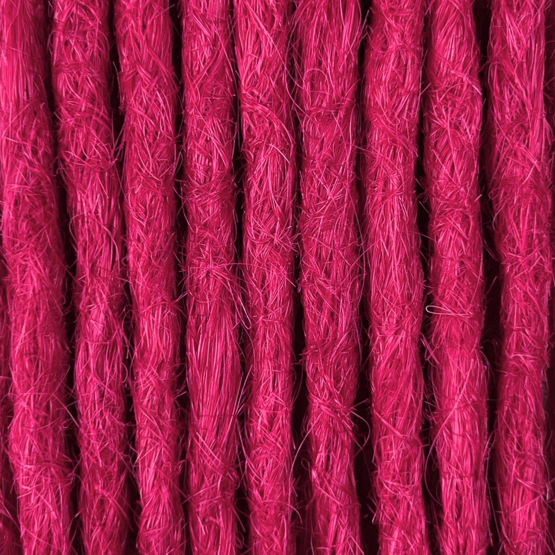 Close-up of straight loc extensions in Magenta Pink, showing the texture and color.
