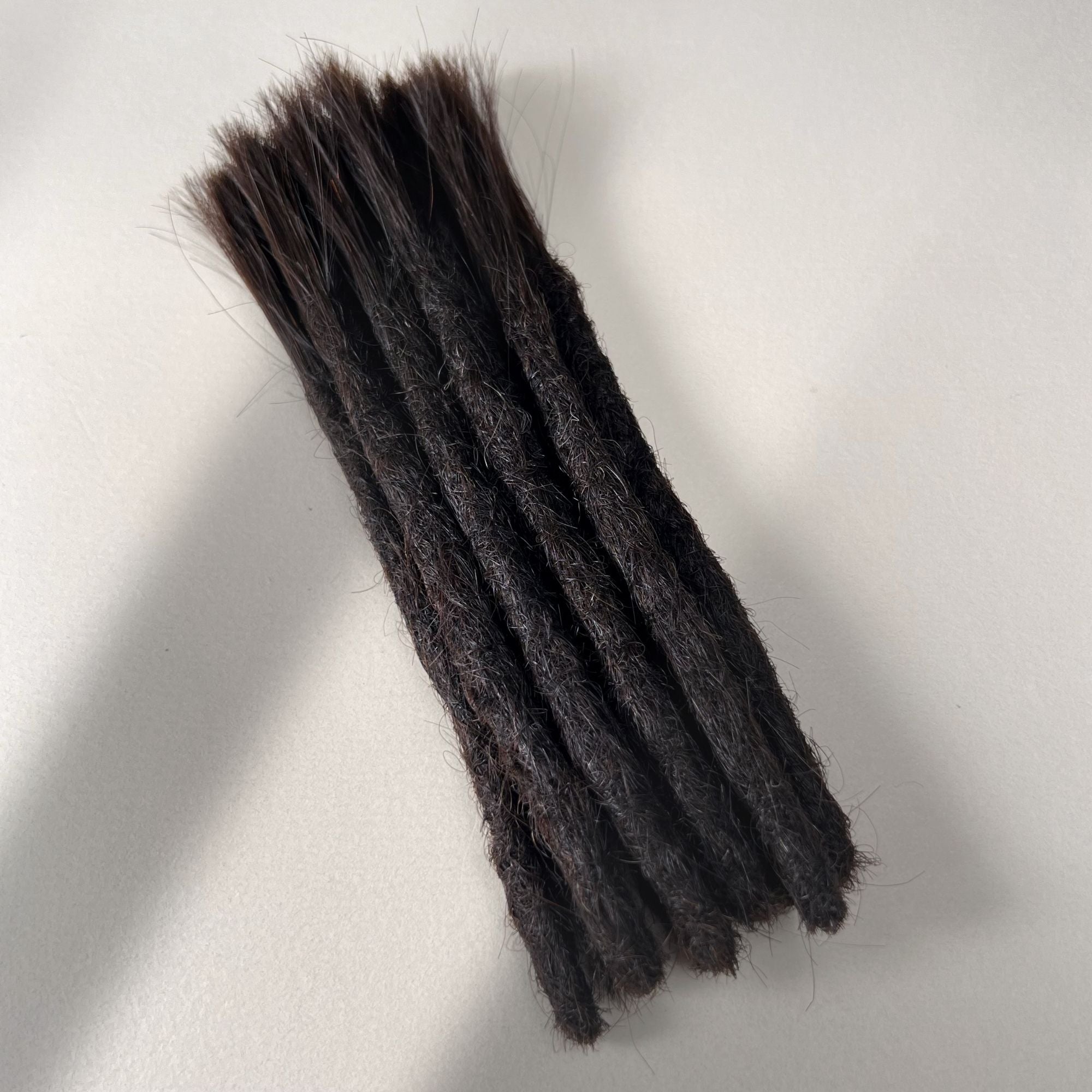Full view of permanent straight loc extensions with blunt ends in Deep Brown.