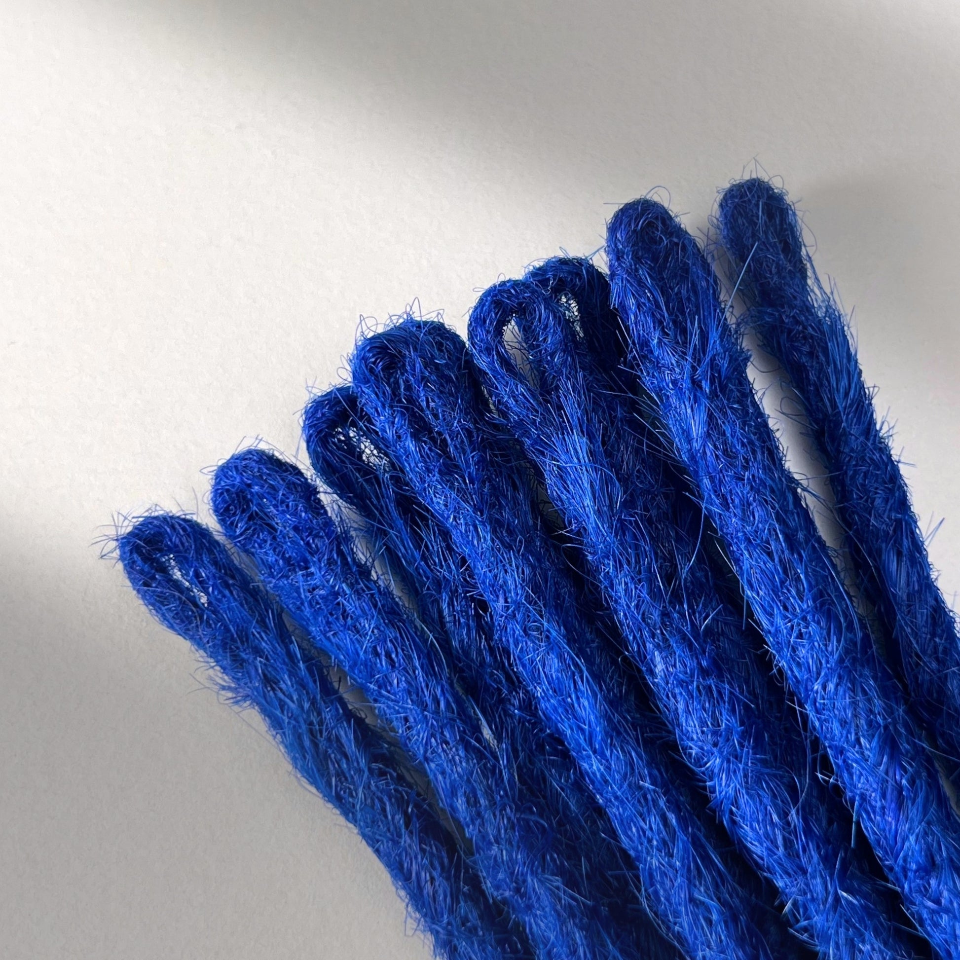 Loop detail of temporary single-ended straight loc extensions in Deep Navy Blue.