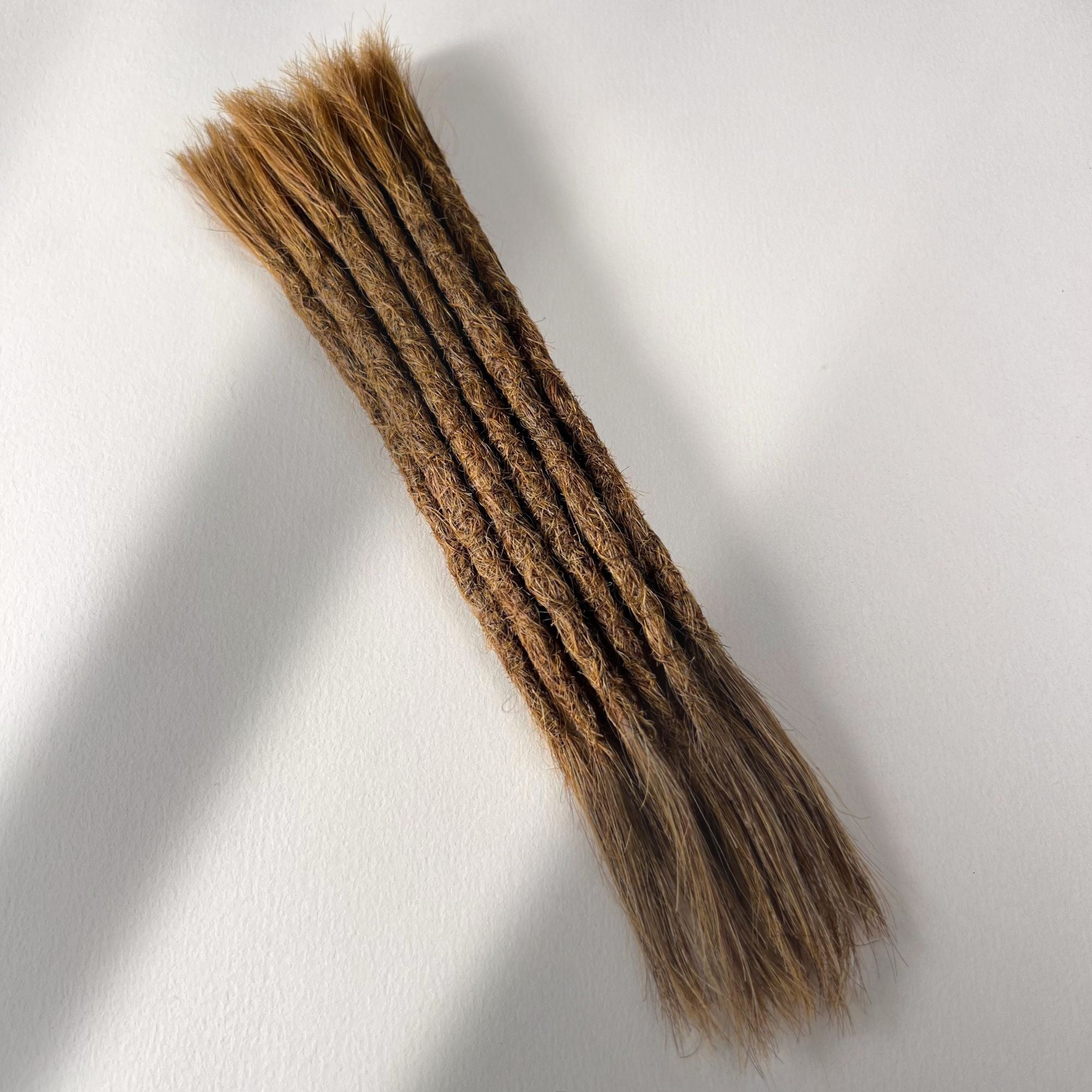 Full view of permanent straight loc extensions with open ends in Warm Chestnut Brown.