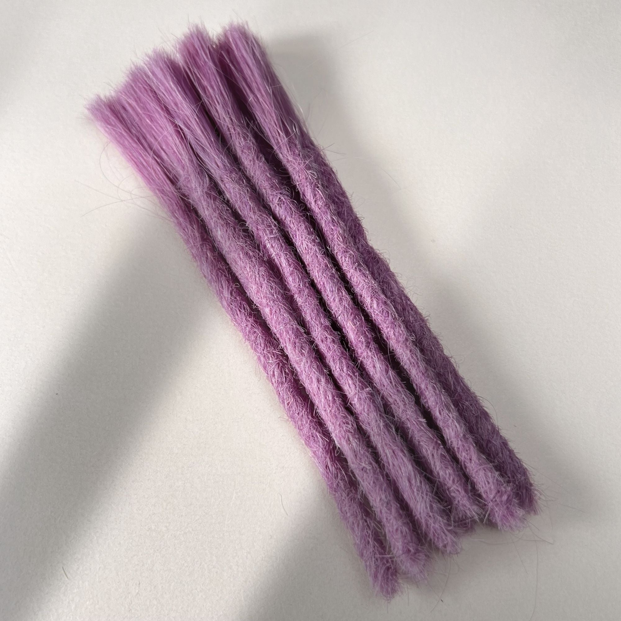 Full view of permanent straight loc extensions with blunt ends in Lavender Purple.