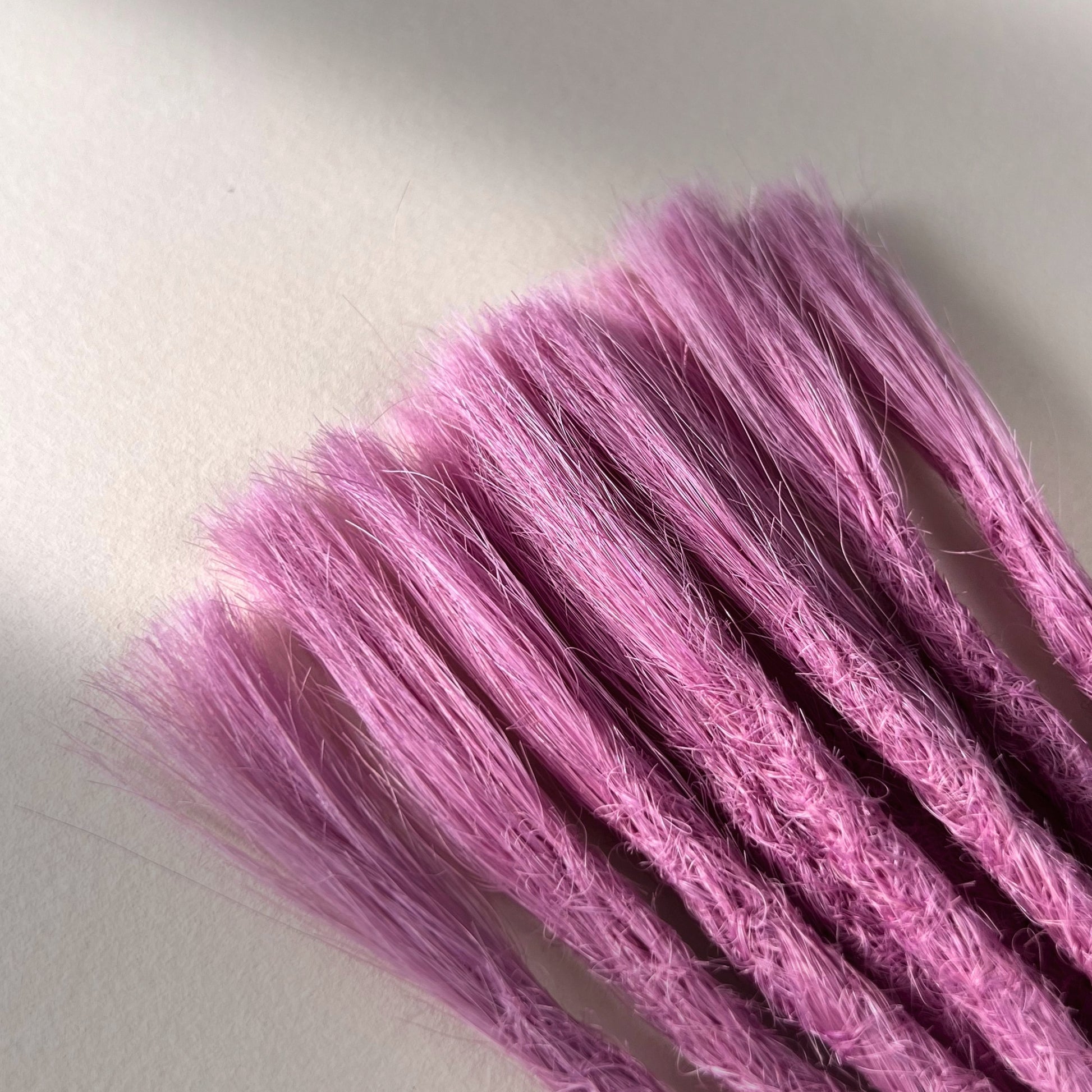 Connection point of permanent straight loc extensions in Lavender Purple.