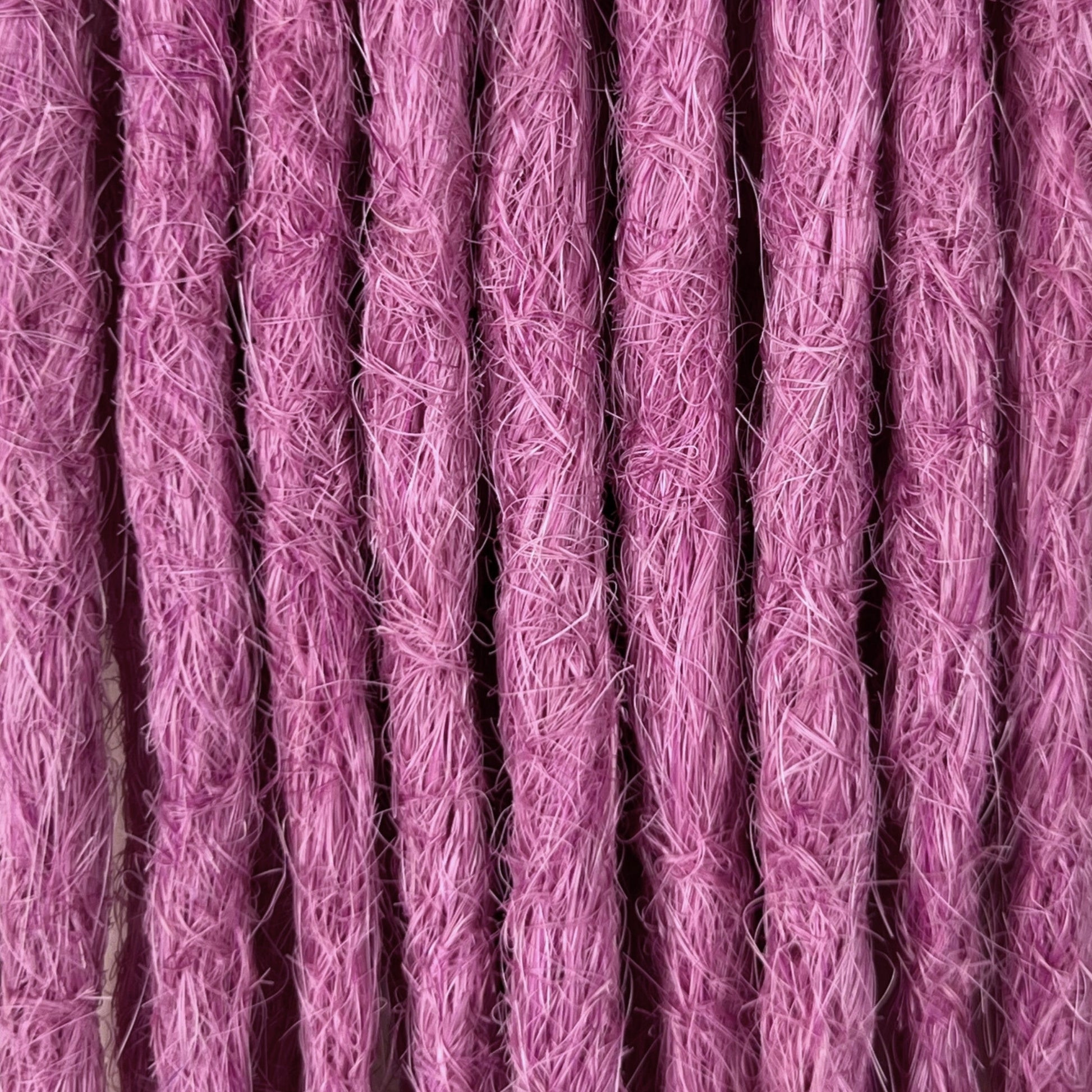 Close-up of straight loc extensions in Lavender Purple, showing the texture and color.