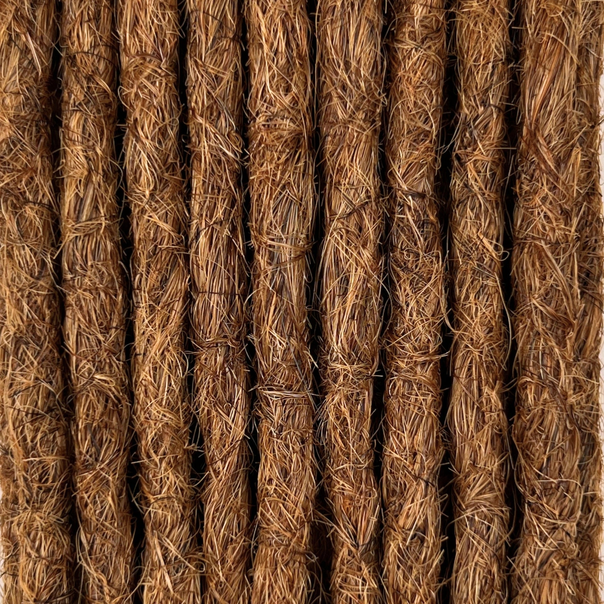 Close-up of straight loc extensions in Auburn Copper, showing the texture and color.