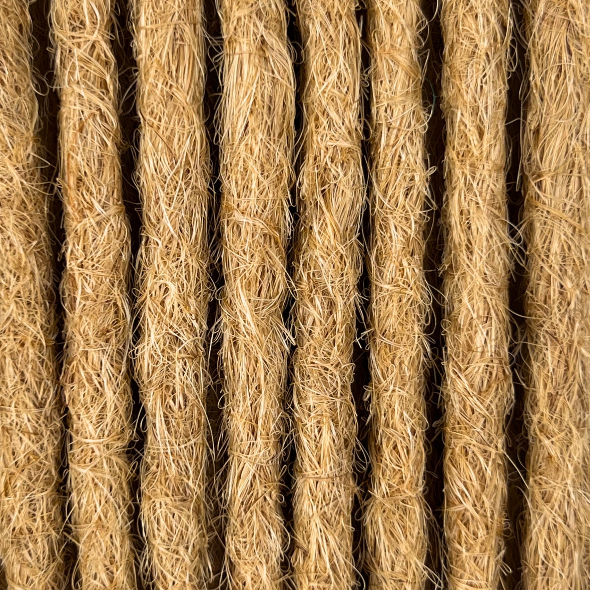 Close-up of straight loc extensions in Sunkissed Blonde, showing the texture and color.