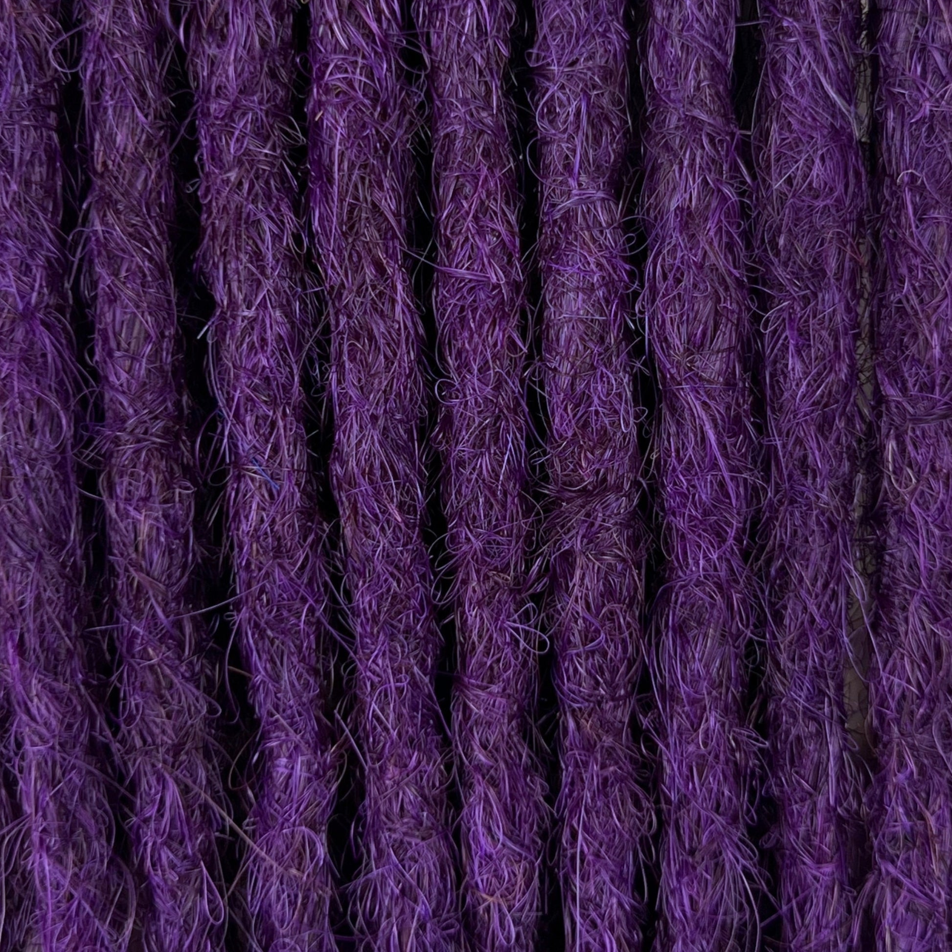 Close-up of straight loc extensions in Electric Violet, showing the texture and color.