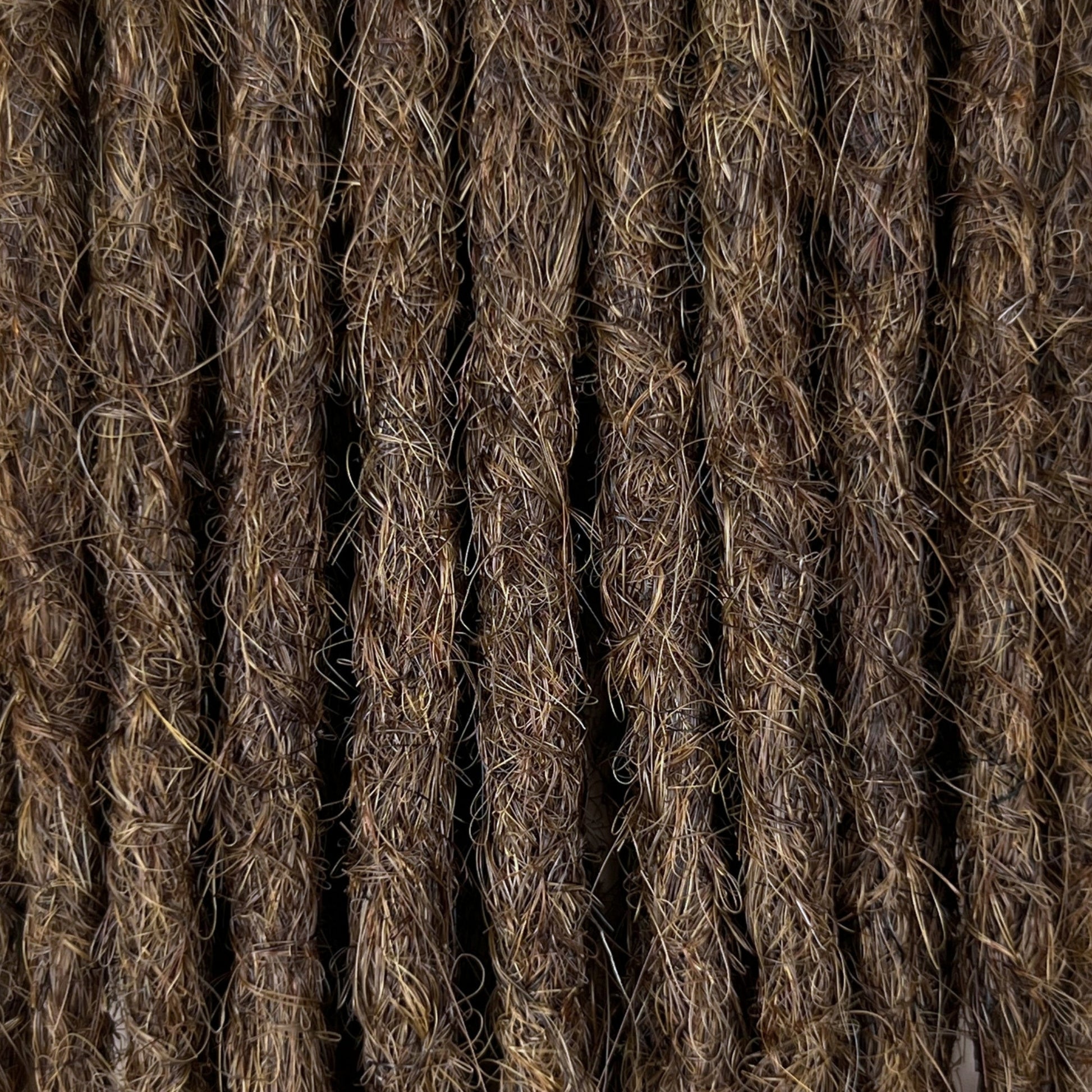 Close-up of straight loc extensions in Medium Brown, showing the texture and color.